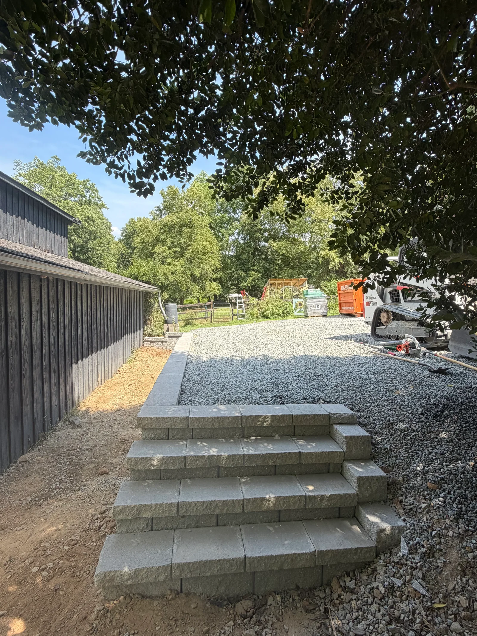Concrete block retaining wall steps with gravel courtyard and landscape edging